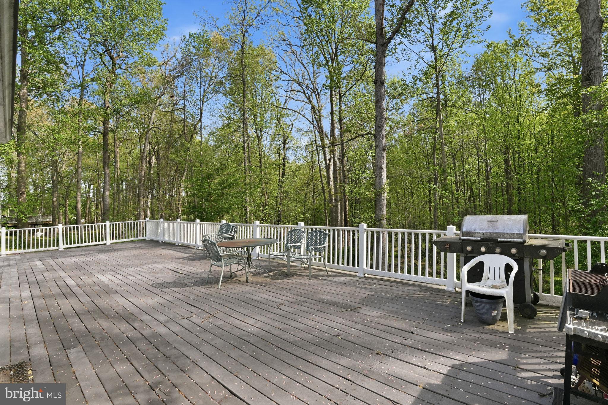 17107 Overhill Road Rockville, MD 20855 - Photo 30 of 37 a view of a deck with a table and chairs with wooden floor and fence