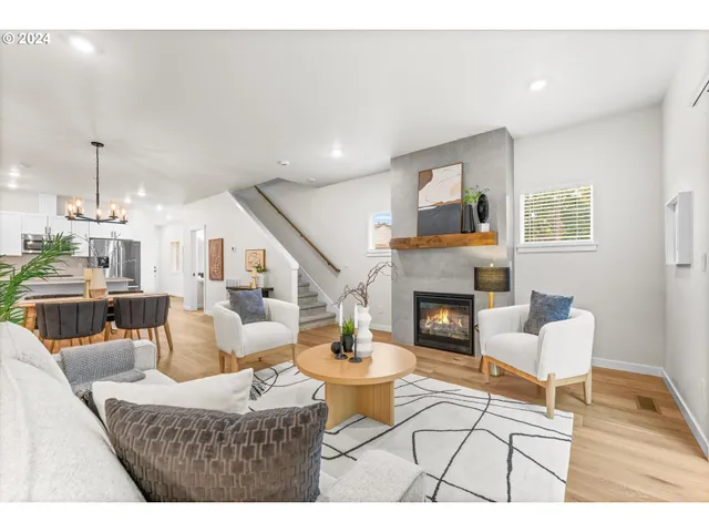 a living room with furniture a fireplace and a table
