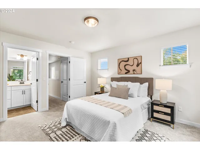 a bedroom with a white bed and a chandelier