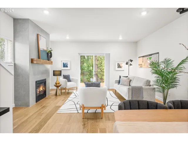 a living room with furniture a fireplace and a potted plant