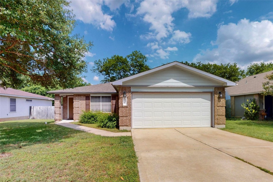 307 Kates Cove Buda, TX 78610 - Photo 1 of 1 a front view of house with yard and green space