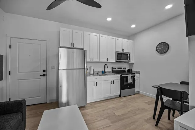a kitchen with cabinets and stainless steel appliances