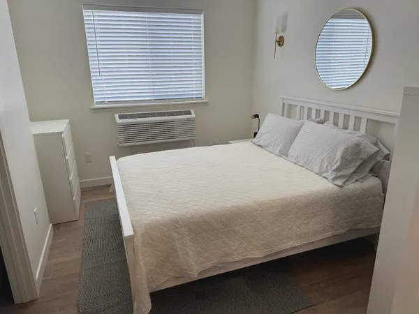 a bed sitting in a bedroom next to a window
