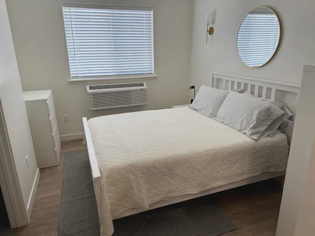 a bed sitting in a bedroom next to a window