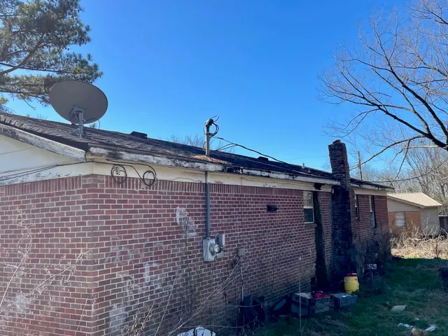 a side view of a house with a backyard
