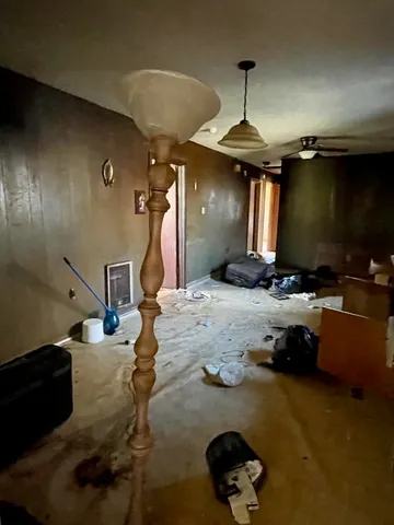 a room with gym equipment and a chandelier