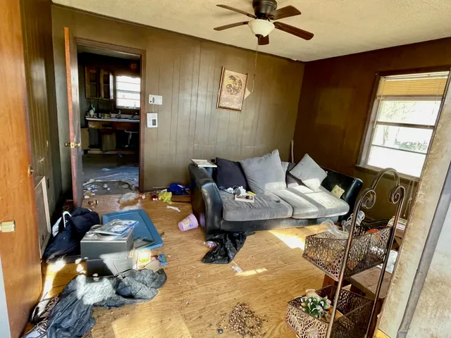 a living room with furniture and a chandelier