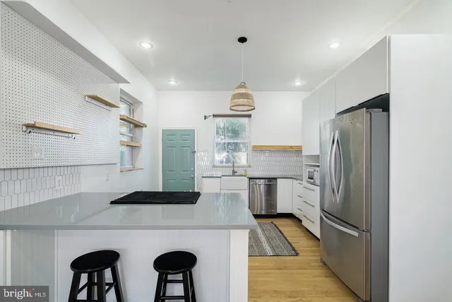 a kitchen with refrigerator and cabinets