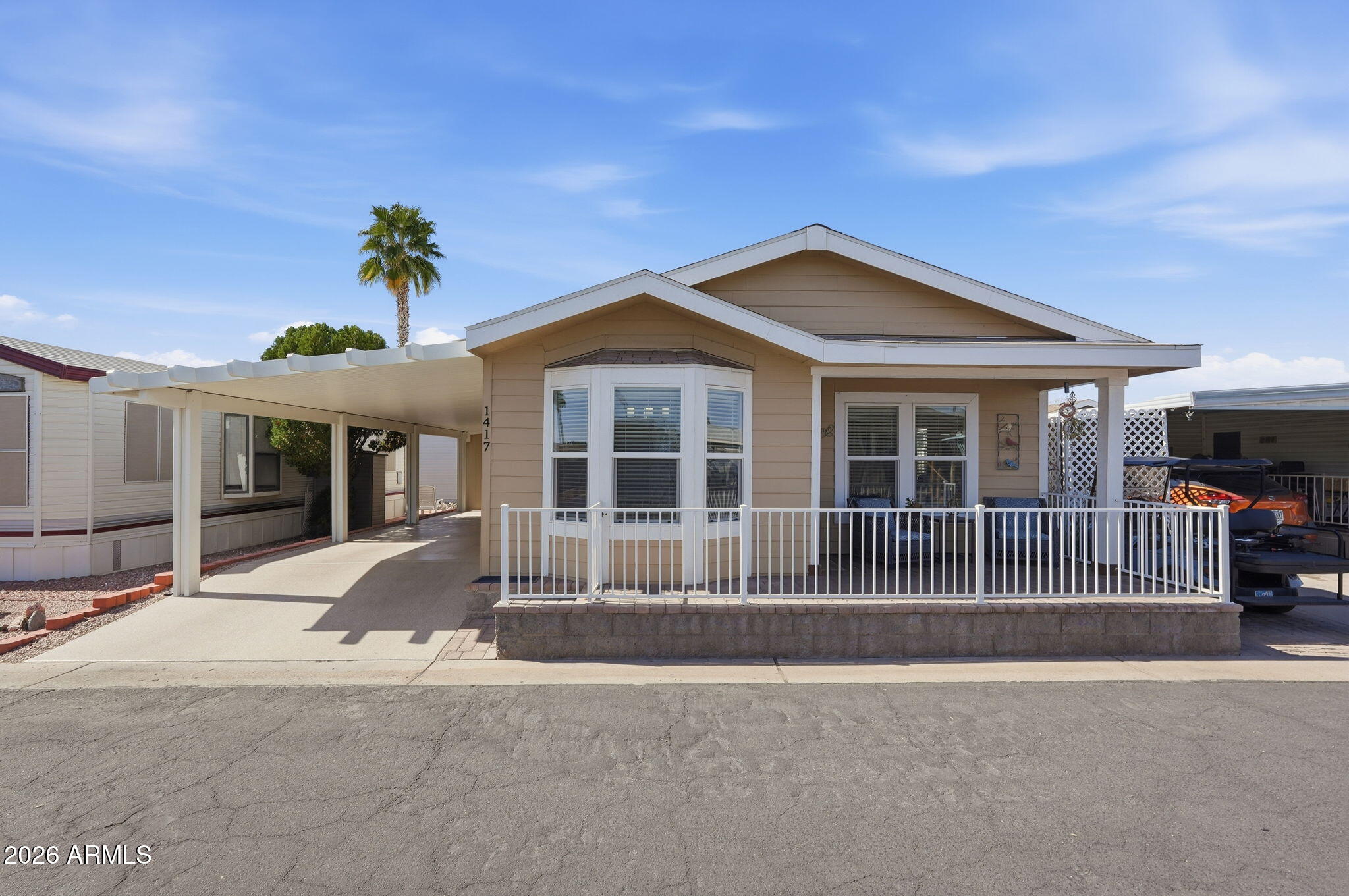 8865 East Baseline Road, Unit 1417 Mesa, AZ 85209 - Photo 1 of 47 a front view of a house with a yard and garage