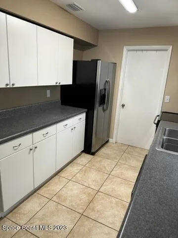 a kitchen with a sink and a refrigerator