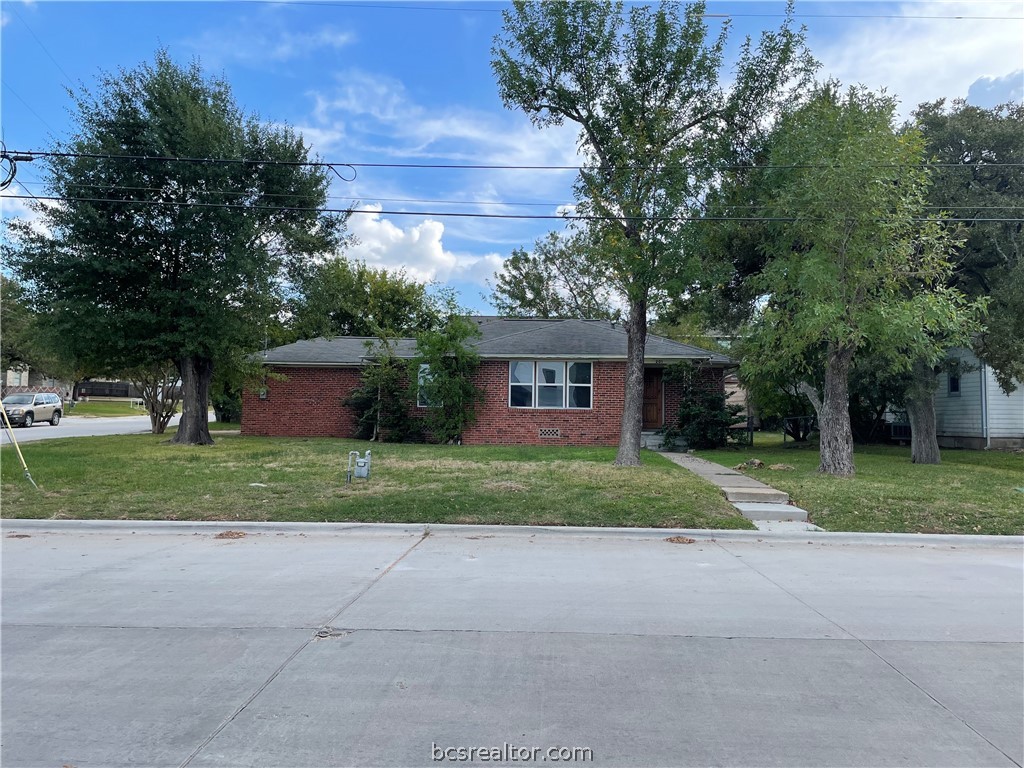 a front view of a house with a yard and a garage