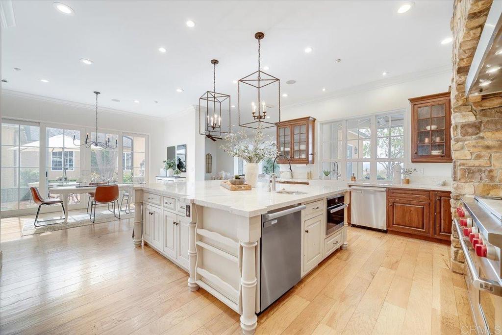 32110 Dos Ninas Bonsall, CA 92003 - Photo 13 of 75 a large white kitchen with a large island in the center