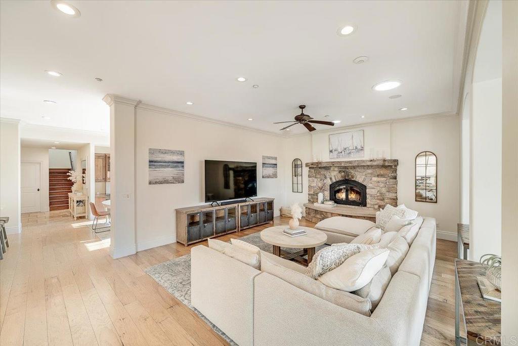 32110 Dos Ninas Bonsall, CA 92003 - Photo 20 of 75 a living room with furniture a fireplace and a flat screen tv
