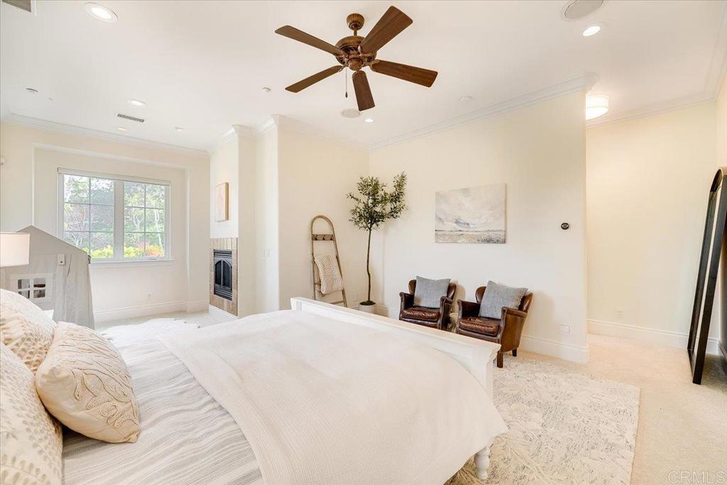 32110 Dos Ninas Bonsall, CA 92003 - Photo 25 of 75 a bedroom with a bed and a chandelier