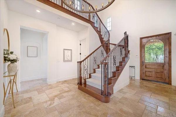 a living room with furniture and chandelier