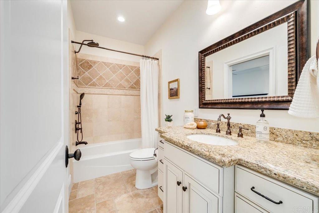 32110 Dos Ninas Bonsall, CA 92003 - Photo 36 of 75 a bathroom with a granite countertop sink mirror vanity bathtub and toilet