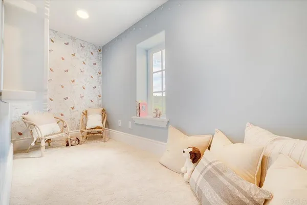 a view of a white house with a yard and potted plants