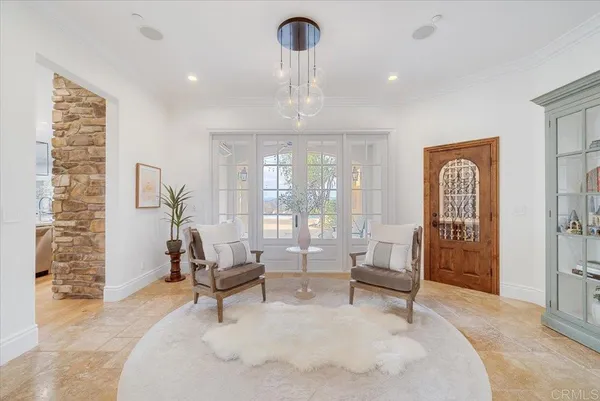 a view of a hallway with wooden floor and a living room