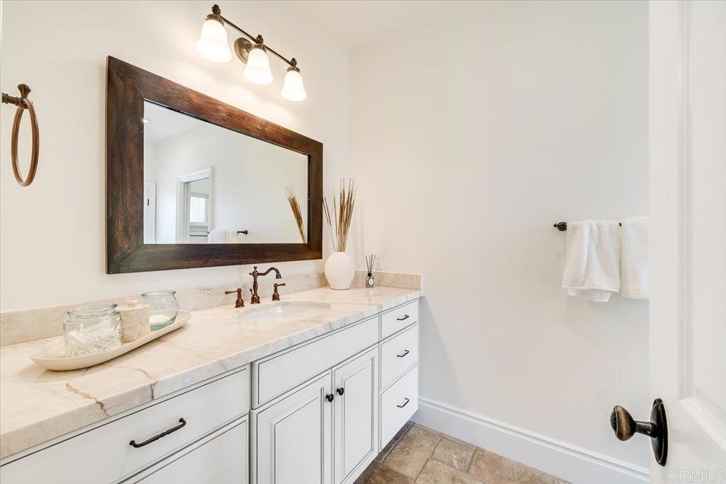 32110 Dos Ninas Bonsall, CA 92003 - Photo 41 of 75 a bathroom with a double vanity sink and a mirror