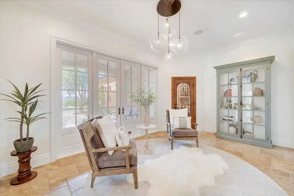 a view of a dining room with furniture wooden floor and chandelier