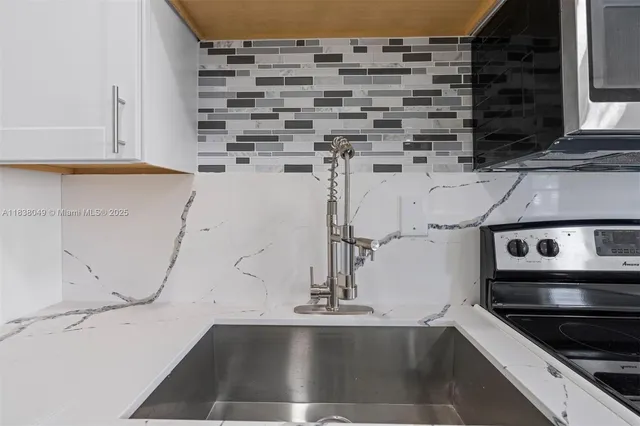 a kitchen with a sink and cabinets