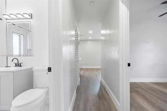 a bathroom with a toilet a sink a shower and mirror