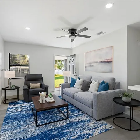 a living room with furniture and a rug