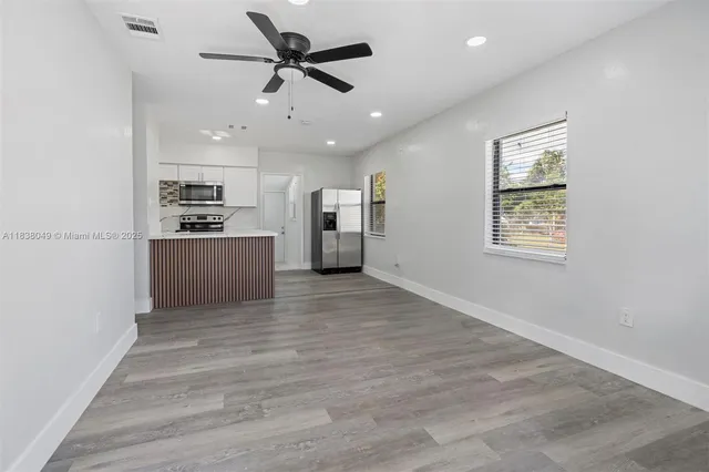 a view of a kitchen with a sink and a refrigerator