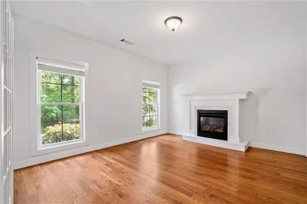 a bedroom with a large bed and a fireplace