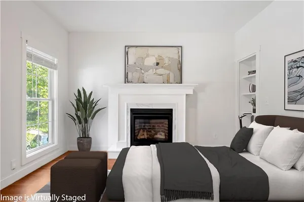 a view of an empty room with window and fireplace