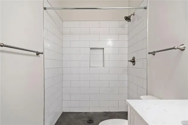 a kitchen with granite countertop a sink stainless steel appliances and cabinets