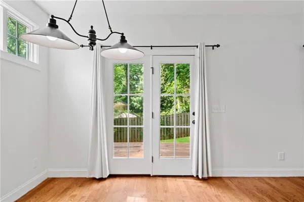 a view of a room with wooden floor and windows