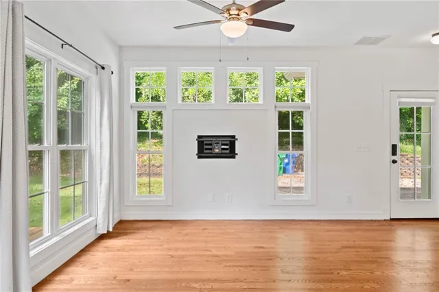 a view of a livingroom with a ceiling fan and window