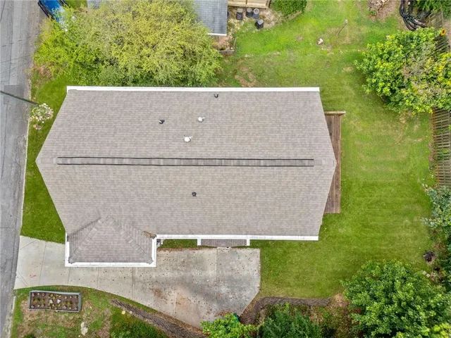 an aerial view of a house with a yard