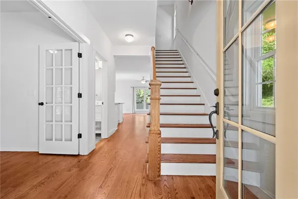 a view of entryway with wooden floor and stairs