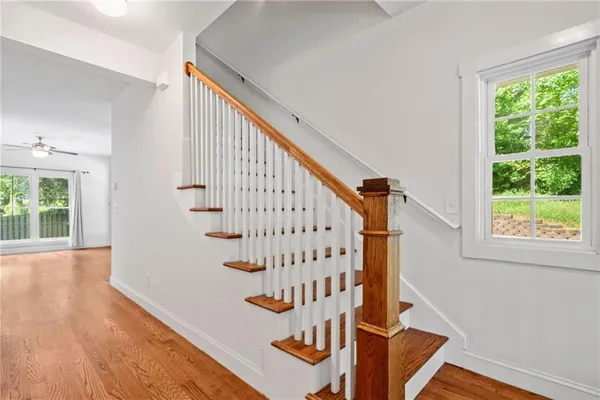 an empty room with large windows and fireplace