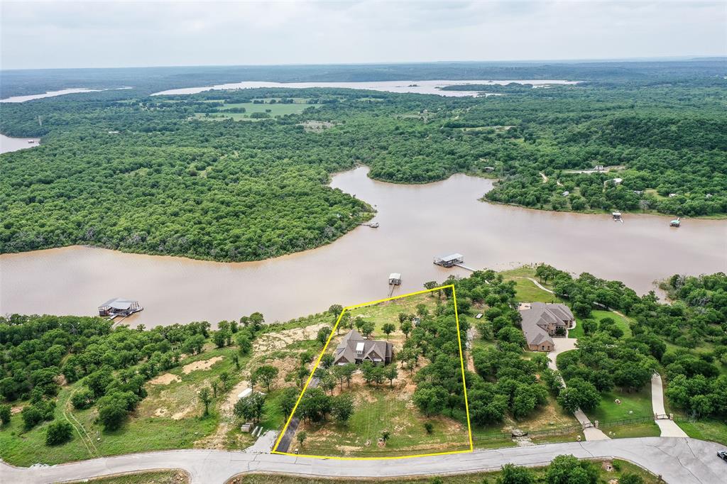 Drone / aerial view featuring a wooded view and a water view