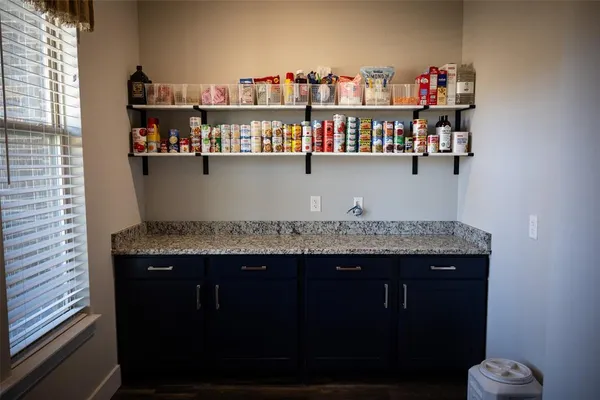 a view of kitchen island with granite countertop stove top oven