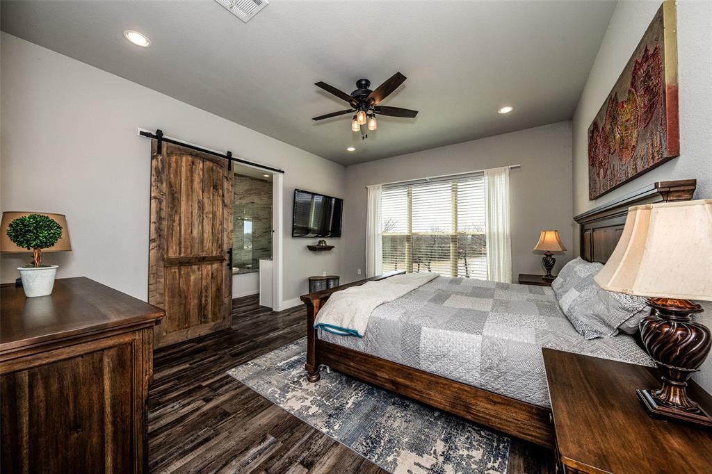 133 Sunset Bay Pointe Court Chico, TX 76431 - Photo 15 of 40 Bedroom with a barn door, recessed lighting, a ceiling fan, visible vents, and dark wood-style floors