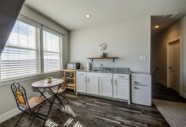 a spacious bathroom with a granite countertop sink and a mirror