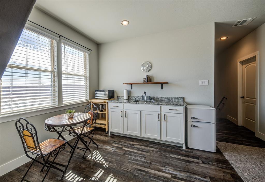 133 Sunset Bay Pointe Court Chico, TX 76431 - Photo 24 of 40 Kitchen featuring a sink, visible vents, white cabinetry, light stone countertops, and open shelves