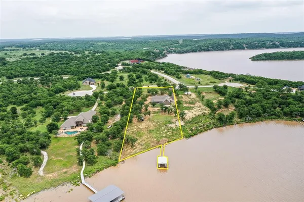 a view of a lake with houses in the back