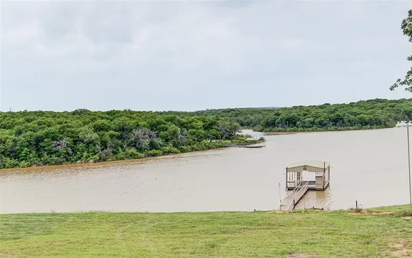 a view of a lake with houses in the back