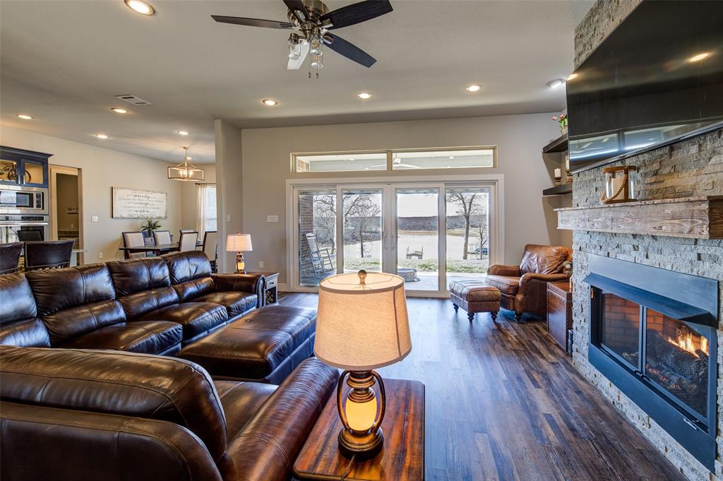 133 Sunset Bay Pointe Court Chico, TX 76431 - Photo 8 of 40 Living room featuring a ceiling fan, recessed lighting, dark wood-style flooring, and a fireplace