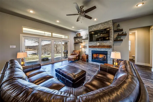 a living room with furniture a fireplace and a flat screen tv