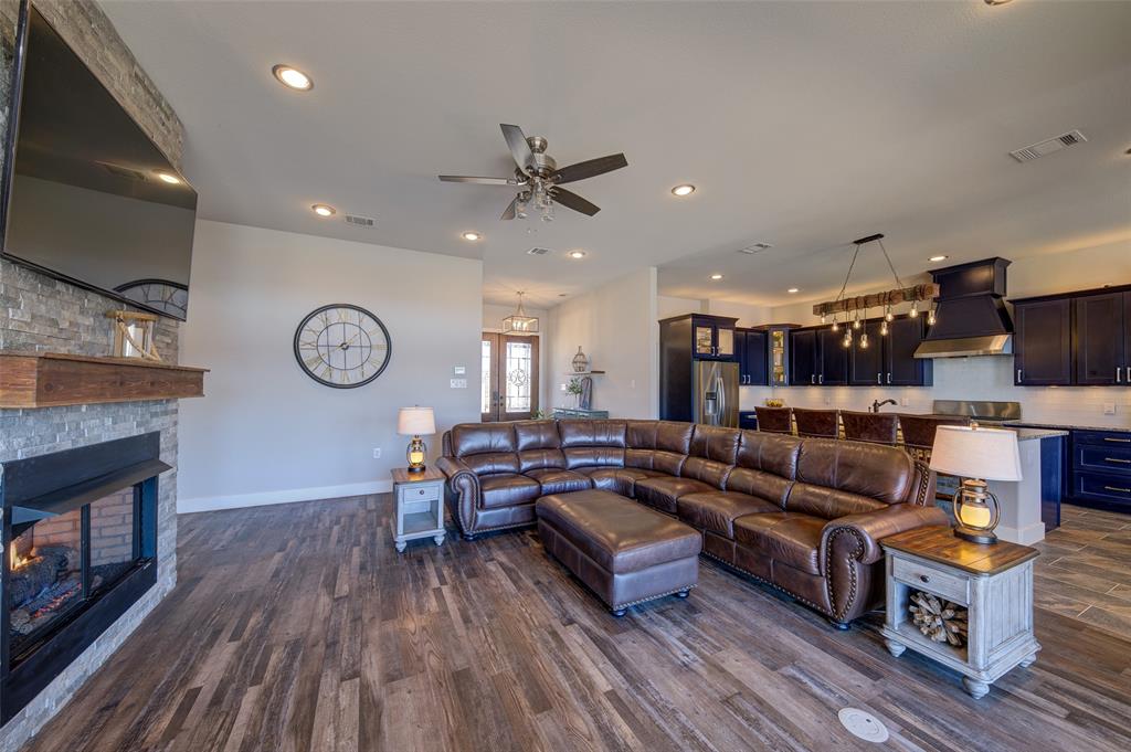 133 Sunset Bay Pointe Court Chico, TX 76431 - Photo 10 of 40 Living area with a stone fireplace, recessed lighting, visible vents, baseboards, and dark wood finished floors