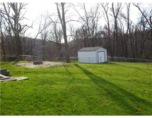 Exterior Back. The backyard is private and HUGE!   If you have an animal or children the yard is already fenced!  Shed has electricity!  Enjoy family picnics and get togethers around the fire-pit area...Notice all of the trees!!  Once the leaves grow in...B-E-A-UTIFIl!