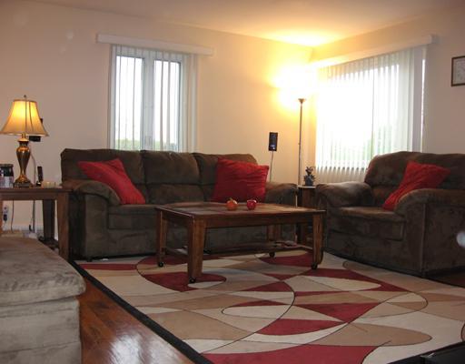 Living Room. Living room is 15 x 16,  Has hardwood flooring and plenty of space for your furniture!  Lots of windows add plenty of natural light into this warm and inviting area.