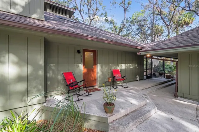 a view of hallway with stairs and a window
