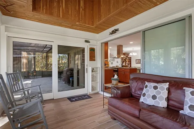 a view of an entryway with wooden floor and a livingroom view